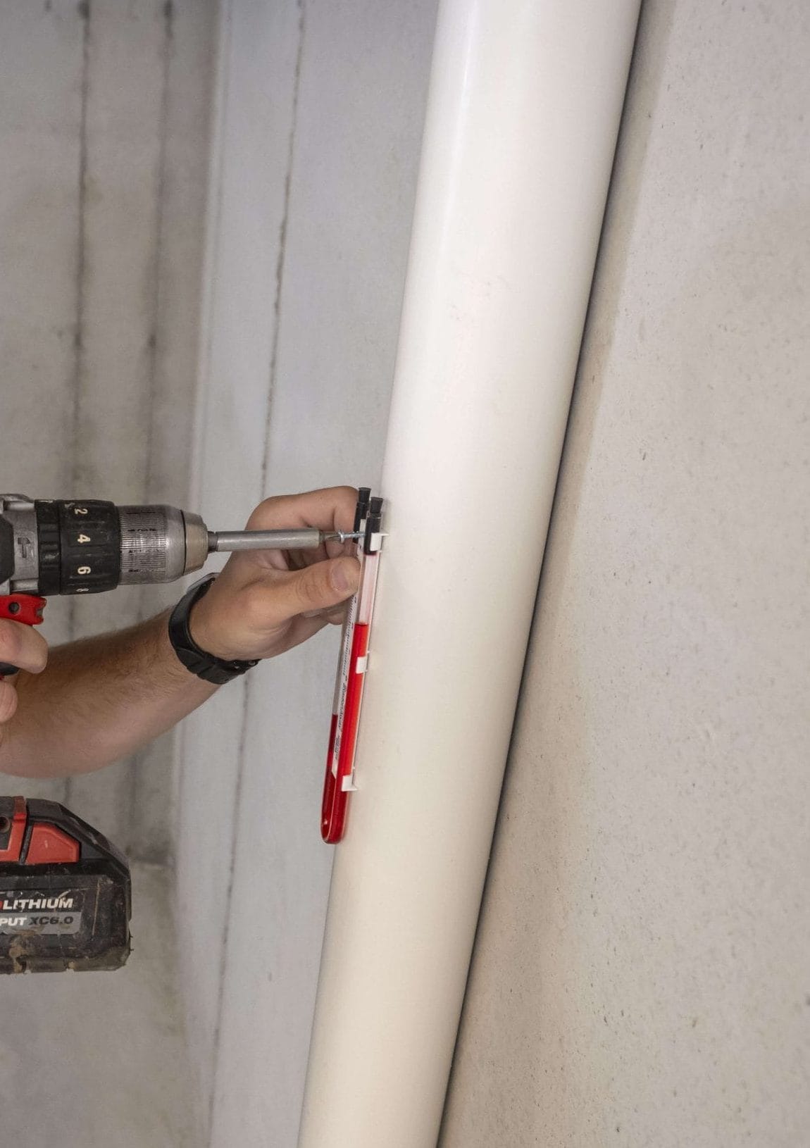 A man fixing radon mitigation system maintenance