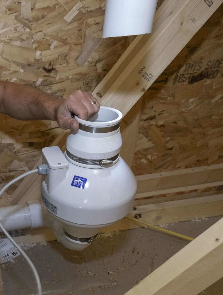 Technician Performing Residential Radon System Maintenance in Attic