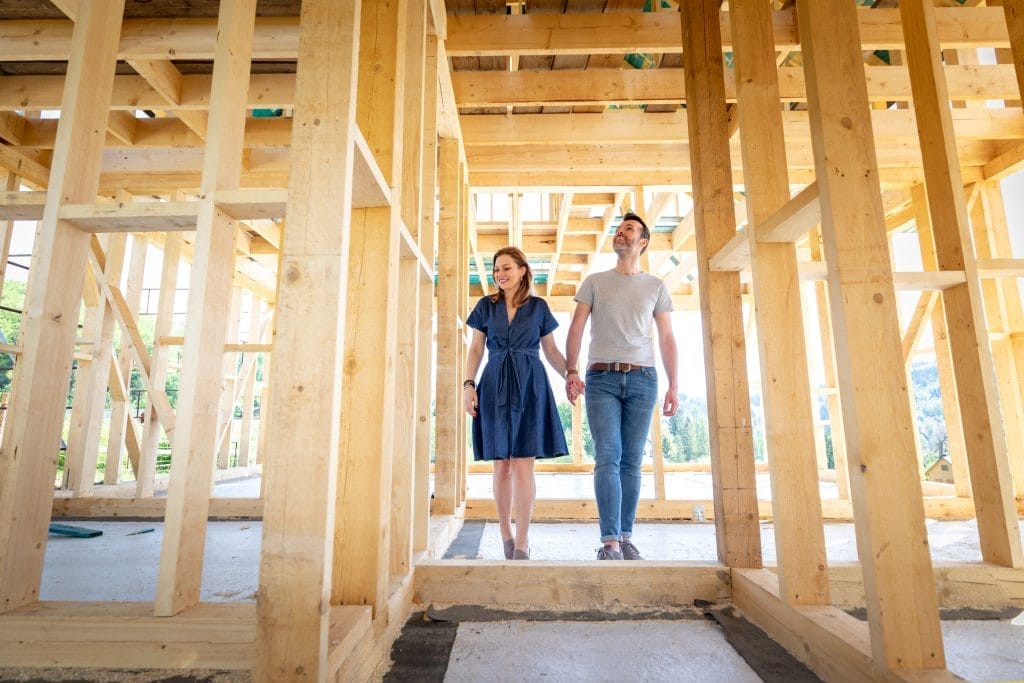 Couple Walking Through New Home Construction for Radon Mitigation
