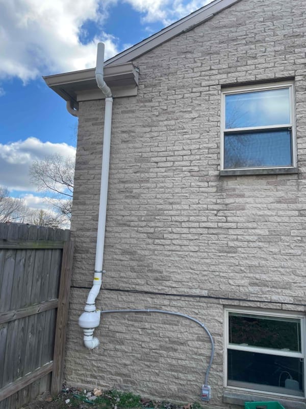 Residential Radon Mitigation System Installed on Brick Home
