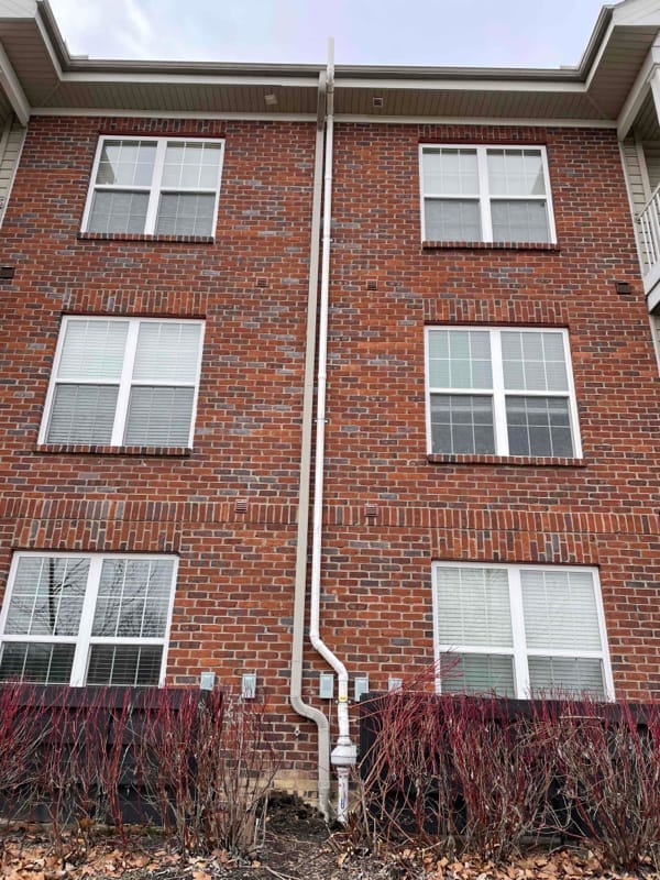 Radon mitigation system on exterior wall of commercial building
