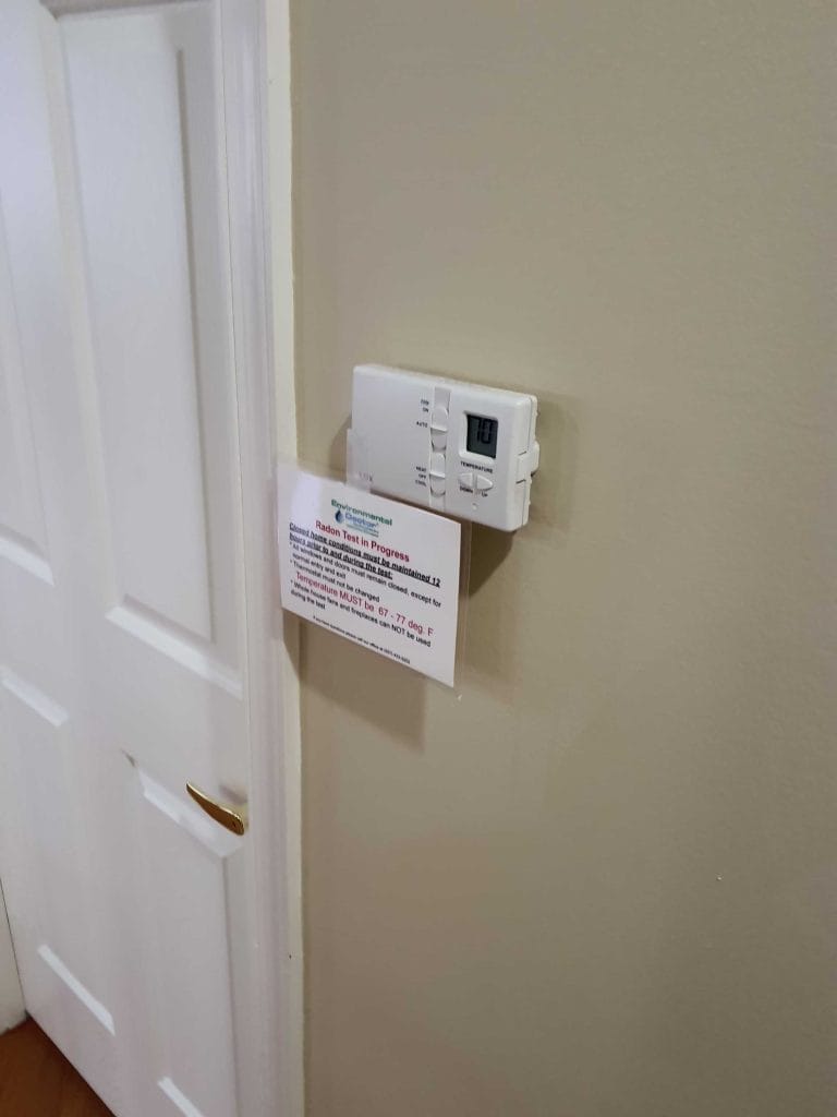 Thermostat on wall used for residential radon testing
