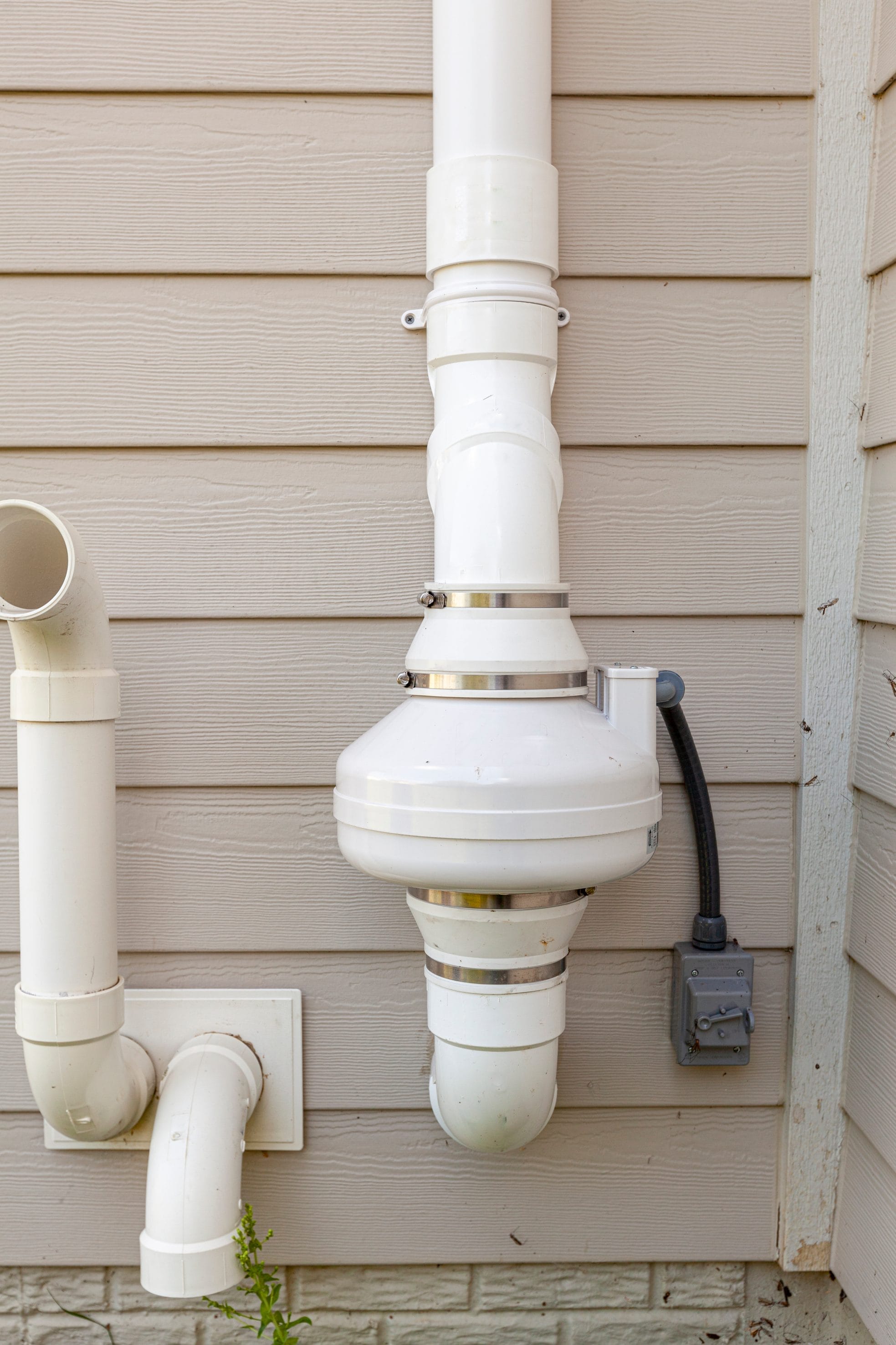 radon mitigation system outside of home representing radon system repair